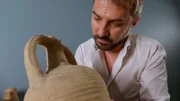 Paolo Maranzana inspects an amphora. (National Geographic)