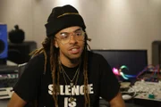Dee-1 sits in a recording studio and smirks.