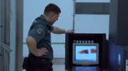 Border officer inspects the x-ray records.
