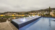 Full view of pool, with 4 wall infinity edge spa jets on, as seen in Pool Kings.