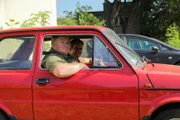 L-R: Mike and Elvis posing inside car.