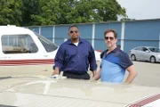 Chris Anderson and Kirk McCardell pose next to a plane.