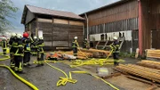 Firefighters are preparing hoses.