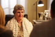 Betty Rickmond stares at Chris Anderson who is seated across from her.