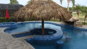 The Hairston Family's brand new pool with a swim up bar covered tiki hut as seen on Pool Kings. (exterior)