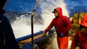 Clark Pederson stays focused, even with waves crashing up behind him on the deck of the Northwestern.