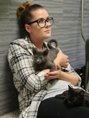 An interested adopter holding a kitten.