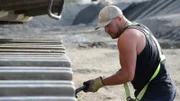 Brennan Ruault cleaning the excavator tracks.