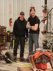 Clint Greathouse, Alex Packard, and Gary Stein talk about the minibike in the shop.