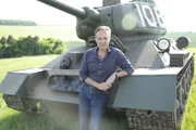 Historian Guy Walters poses for a portrait standing in front of a T34 tank in Salisbury, United Kingdom. (National Geographic)