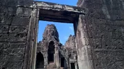 Der steinerne Durchgang zum Bayon-Tempel in der Palast-Anlage von Angkor Wat in Kambodscha ist mit Reliefs bedeckt.