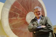 Christopher Clark steht in Jantar Mantar, einer Sternwarte in Jaipur, vor einer riesigen Sonnenuhr.