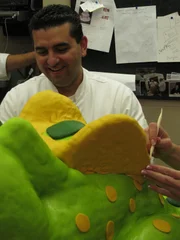 Dragon Cake and Roller Skate Cake. Buddy works on the dragon cake.