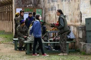 Saryas (Souheila Yacoub, vorne re.) und Nisrins (Tasnim Cheham, vorne li.) Bindung wird immer stärker: Sarya überreicht ihr ihre Uniform und nimmt sie in den Kreis der YPG-Kämpferinnen auf.