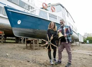 Eva und Sebastian Gehrlein vor ihrem Wohnschiff „Grafenwerth“.