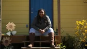 Myesha smiling on her front stoop