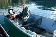 PORT PROTECTION, ALASKA- Sam Carlson prepares to filet a halibut he caught earlier in the day. (Photo Credit: National Geographic Channels/Gregory Schmittel)