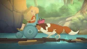 Lassie hilft Judith, über die behelfsmäßige Brücke auf die andere Flussseite zu kommen, wo die Wanderung fortgesetzt werden soll.
