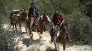 Chad Ollinger (r.) and Josh Feldman ride their horses up the trail.