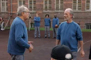 Klaus (Hartmut Volle, l.) provoziert Pacholke (Thomas Anzenhofer, r. mit Komparsen, h.).