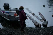 PORT PROTECTION, ALASKA- Mary Miller strings logs together in order to tow them back home. (Photo Credit: National Geographic Channels/Gregory Schmittel)