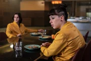Kyra (Marli Siu, r.) und James (Earl Cave, l.) beobachten traurig ihre Mitschülerin am Nebentisch. Sie ist völlig verändert und verhält sich wie ein Roboter. Die beiden machen sich große Sorgen.