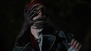 A pair of black demon hands with long nails wraps around the teenage PIRATE'S head in the woods at night.
