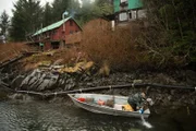 PORT PROTECTION, ALASKA- Tim "Curly" Leach skiffs from island to island in search for fresh signs of land otters in Port Protection, AK. (Photo Credit: National Geographic Channels/Joshua "J.J." Krehbiel)