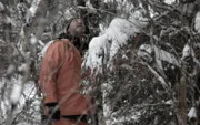 Hans inspects the tree they're going to cut down.