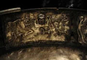 The Gundestrup cauldron. Decorated silver vessel, thought to date between 200 BC and 300 AD, placing it within the late La Te_ne period or early Roman Iron Age. Gundestrup in the Aars parish of Himmerland, Denmark. Scene showing the bust of a bearded god who holds a broken wheel in his righ hand, sometimes identified with the Celtic thunder god Taranos. The wheel is supported by a smaller figure with a horned helmet depicted in a jumping stance. Below the group is a single ram-horned serpent, three griffins and a pair leopards. National Museum of Denmark.