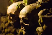Human skulls lining the walls of the ancient Catacombs in Paris, France.