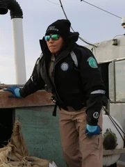 Warden Chelsea Bailey surveys an oyster boat.