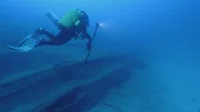 The underwater dive team finds results of the underwater nuclear test Baker on battleship USS Arkansas.