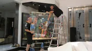 Wayde and Brett put sand in the tank.