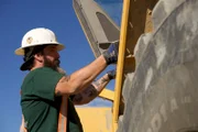 Ryan Hofer getting into a rock truck.