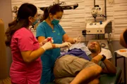Dr. Sandra Lee and Medical Assistant Val perform surgery on Luis.