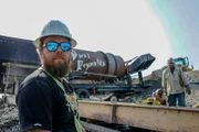 Carl Rosk looking at camera with ‘Durt Reynolds’ washplant in the background.