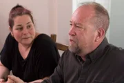 Homeowners Carl and Cindy Danielson sit at table during the evidence reveal.