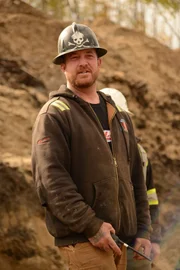 Rick Ness holding a radio mic.