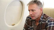 Glenn ponders his decision to leave his home while aboard his jet.