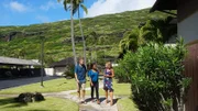 Home buyers Nalani Kuglin, Matthew Kuglin, and realtor Jodi Mews walking outside Keokea house as seen on Hawaii Hunters (Action)