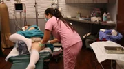 The Dr. Pimple Popper Crew films Dr. Sandra Lee as she performs surgery to remove the lipoma from Heather's bottom.