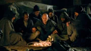 Adam and homeless people mourn together.