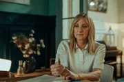 Hannah Laing (Lesley Sharp) sitting at table