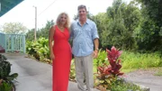 Home buyers Vikki Gaul (L) & Tom Gaul (R) standing on the walkup to the Hawaii Belt Rd house as seen on Hawaii Hunters (portrait)
