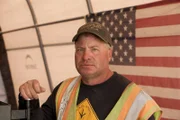 Freddy Dodge in front of American flag.