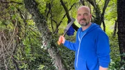 Ralf Gerstenlauer looks at the affected area on an abandoned property after partial clearing