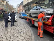 Die Städtischen Verkehrspolizisten Rainer Deckert und Stephan Janisch lassen ein Auto aus der Parkverbotszone abschleppen.