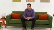 City Stages, NYC - Full shot of Host Jason Silva on a white set and green couch.