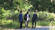 Greg Knighten, Jonathan Jobe and Richard Goggling standing around in the street.